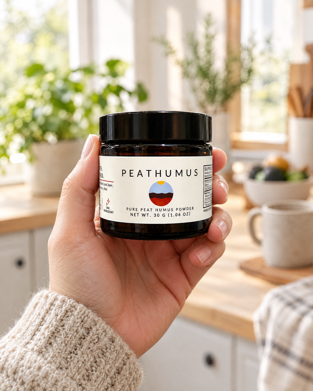 Hand holding a jar of Peathumus